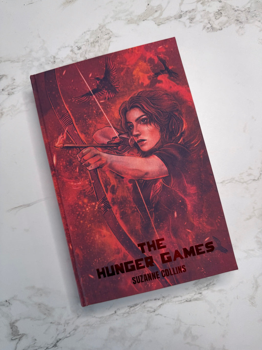 The Hunger Games by Suzanne Collins in Collaboration with Atreiyus
